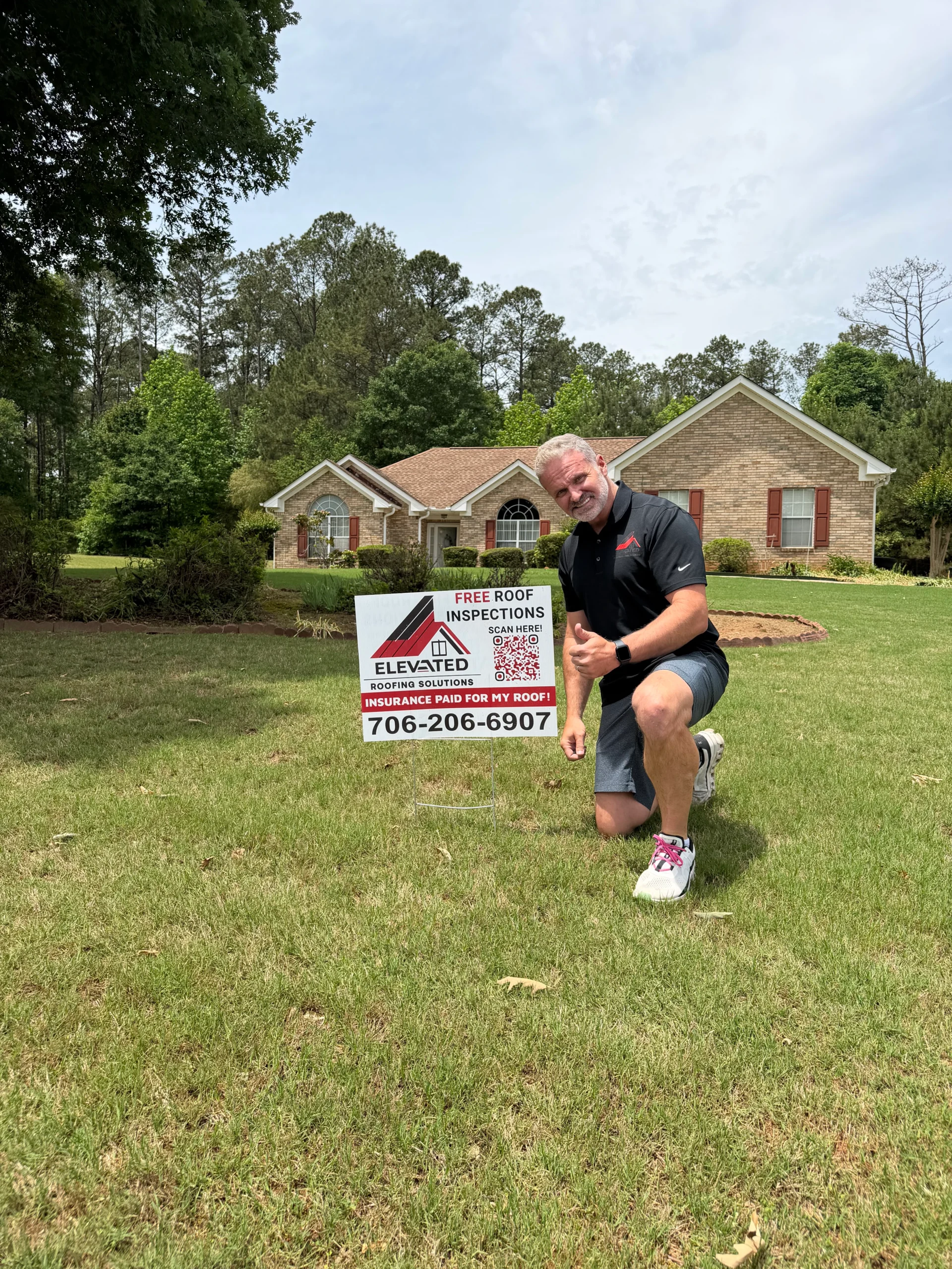 Roofer inspecting and working on a residential roof in Atlanta